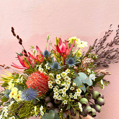 Bushland Birthday Wishes native flower arrangement featuring proteas, banksias, and wax flowers designed by FLORAqueen Fitzroy North